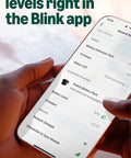 Person holding phone showing Blink app with Solar Panel Security Accessory For Outdoor 4 And Outdoor 2K Plus Battery Cameras.