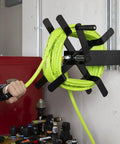 Open Face Air Hose Reel Three Eighth Inch By 50 Foot Heavy Duty Lightweight Hybrid ZillaGreen with swivel handle in use.