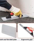 Using a tool from the 4 Piece Concrete Hand Tools Set With Magnesium Hand Float 16x3-1/8 to smooth a cement surface, ergonomic grip visible.