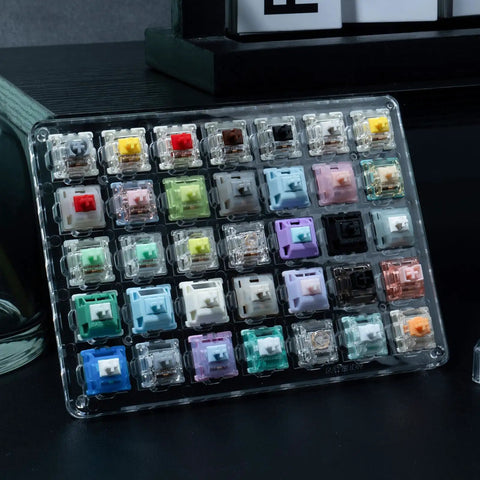 Magnetic And Mechanical Keyboard Switches Tester Kit 35 Piece Set Featuring 4 Magnetic Switches And 31 Mechanical Switches, Perfect For Quick Swaps, Tuning Your Board, And Real Deal Keyboard Enthusiasts. clear case with 35 keyboard switches