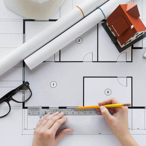 Drafting scene with hands using two piece 6 inch pocket ruler flexible stainless steel with detachable clips dual scale inches and centimeters.