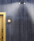 Outdoor Security Flood Light Dual Head 20W LED Bullet Style Flood Light 1900 Lumens IP65 mounted on wall by yellow door