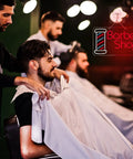Lit Barber Shop Neon Sign For Wall Decor LED Neon Lights Red Blue White 24 By 13.8 Inch Indoor Display in a barbershop setting