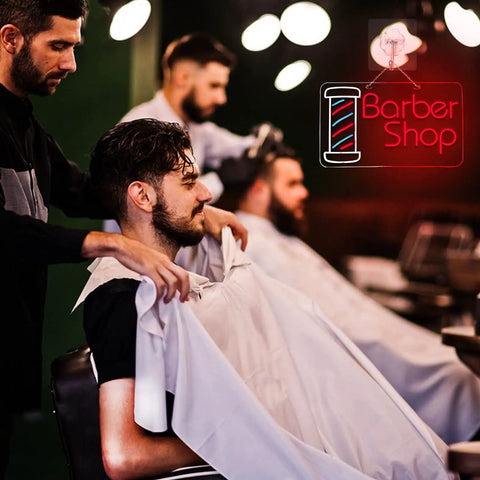 Lit Barber Shop Neon Sign For Wall Decor LED Neon Lights Red Blue White 24 By 13.8 Inch Indoor Display in a barbershop setting