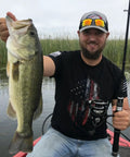 Angler holding a large fish with a Telescopic Fishing Rod And Reel Combo With Carrier Bag For Freshwater Angling Lightweight Two Piece Set