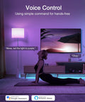 Smart A19 Color Changing LED Bulbs 4 Pack With Dimmable RGB Lighting 2700K Warm White 800 Lumens E26 Base No Hub Needed 2.4GHz Wi Fi Works With Alexa And Google Assistant App Control, voice-controlled lighting in living room with lamp.