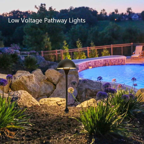 Go To Low Voltage G4 LED Path Lights For Outdoor Landscape Lighting In Oil Rubbed Bronze With Warm White Glow next to a pool.