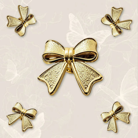 Six Piece Zinc Alloy Bow Drawer Knobs With Vintage Plating And Smooth Curved Handles For Dressers And Vanity Furniture Upgrades That Bring Main Character Energy To Your Space showing elegant gold bow knobs in varying angles.
