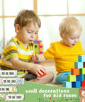 Two young children playing with blocks in a room with 4 Piece Baby Nursery Wall Art Set Unframed Woodland Animal Prints on walls.