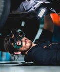 Man using Kickass Dual Flip Up Welding Goggles Built Tough As Nails With Impact Resistance under a vehicle.