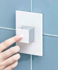 Hand pressing Adorne 20 Amp Pop Out Outlet One Gang In Gloss White With Matching Wall Plate Two Plugs Tamper Resistant Shutter