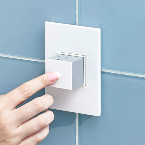 Hand pressing Adorne 20 Amp Pop Out Outlet One Gang In Gloss White With Matching Wall Plate Two Plugs Tamper Resistant Shutter