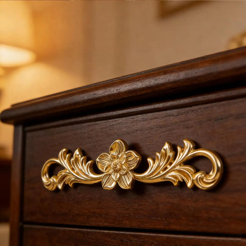 Upgrade Your Furniture Game Now With These Hella Charming Golden Floral Cabinet Handles And Vintage Drawer Pulls Designed To Bring Major Retro Swagger To Dresser Drawers And Bedroom Wardrobe Cabinetry Projects Instantly, close-up view of gold floral handle on dark wood drawer.