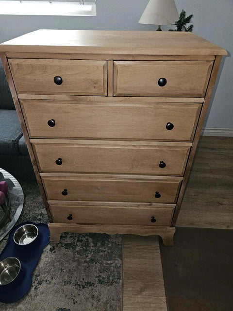 Wooden dresser with 50 Pack Matte Black Round Cabinet Knobs With Edge Detail For Kitchen Cabinets And Drawers.