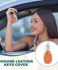 Genuine Leather Key Fob Covers Set 3 Pieces With RFID Protection in use by woman holding keychain in car, orange leather.