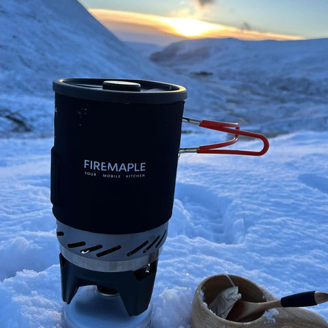 Fixed Star 1 Backpacking Stove System With Propane Cooking Gear on snow with sunset view