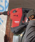 Worker using Beast 120 Volt SDS Max Corded Rotary Hammer Drill Kit With AVR Vibration Reduction Includes TE 70 Rotary Hammer