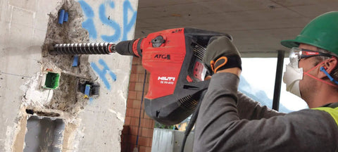 Worker using Beast 120 Volt SDS Max Corded Rotary Hammer Drill Kit With AVR Vibration Reduction Includes TE 70 Rotary Hammer