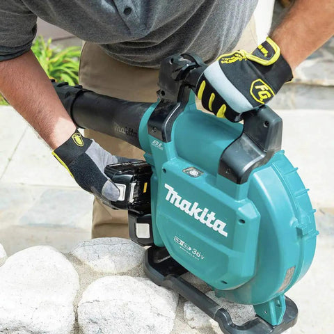 Game Changing Cordless Leaf Blower Kit Equipped With A Brushless Motor Pumping 473 CFM And 120 MPH Air With Zero Hassle Cruise Control and Rapid Swap Batteries for Knocking Down Piles and Hauling Leaves Straight, user adjusting battery.