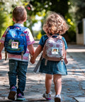 Two children walking with backpacks featuring 36 Pack Crayon Photo Nameplates For Classroom Desks And Cubbies Self Adhesive Name Tags.
