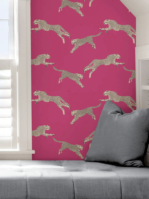 Dope Pink Leaping Cheetah Peel And Stick Wallpaper decorating a living room wall near a window and gray couch.