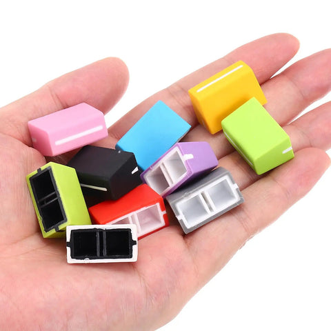 Hand holding colorful Universal Fader Knobs For DJ Controllers And Mixers Green Rubber Slider Caps For Potentiometer