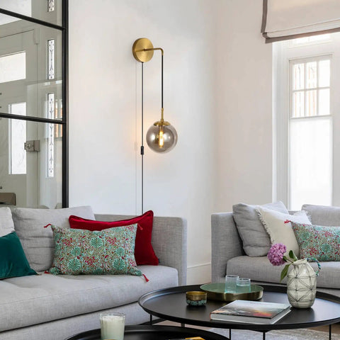 Set Of 2 Plug-In Wall Sconces With Brushed Brass Finish And Smoke Grey Glass Globes, Dope Modern Mid-Century Wall Lamps in living room.