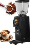 Sleek Electric Espresso Coffee Grinder With 83 Millimeter Flat Burrs And Sharp Color LCD Touchscreen 1000 Gram Bean Capacity beside a cup of coffee.