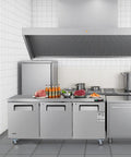 Tough 72 Inch Wide Commercial Undercounter Freezer With Triple Locking Doors And Smooth Rolling Casters, 17 Point 7 Cu Ft Stainless Steel Prep Worktable in a professional kitchen.