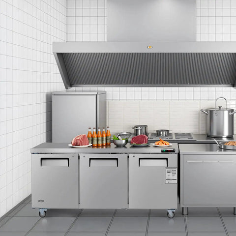 Tough 72 Inch Wide Commercial Undercounter Freezer With Triple Locking Doors And Smooth Rolling Casters, 17 Point 7 Cu Ft Stainless Steel Prep Worktable in a professional kitchen.