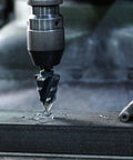 Cobalt Step Drill Set M35 Four Groove Spiral Flute 19 Step Size From One Quarter To One And Three Eighths Inch in use on metal.