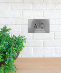 15 Amp Us Standard Wall Outlet With Dual Usb Charging Ports, Built Tough Pp Housing With Genuinely Solid Bronze Contacts, No-Hassle Hookup For Desk Lamps And Bedside Tables, Secure Screw Mount Receptacle on a grey wall with green plant.