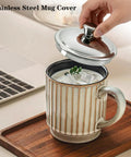 Solid Stainless Steel Universal Mug Lid Keeps Your Morning Grind Hot And Clean With Zero Fuss on a ceramic mug with ice.