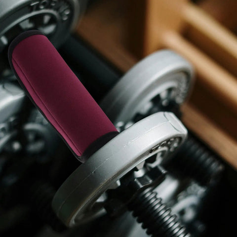 Two Pack Detachable Neoprene Pull Up Bar And Barbell Pad Covers With Anti Slip Grip on barbell in gym setting