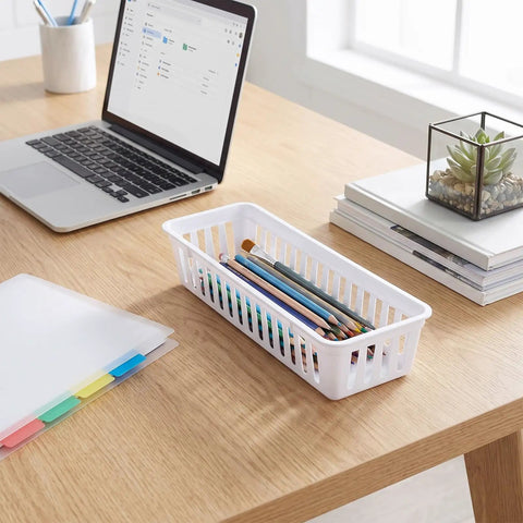 Eighteen Pack Slick Slim Plastic Baskets For Narrow Drawer Setup with office supplies on a desk, 10 x 3 inch white storage tray.