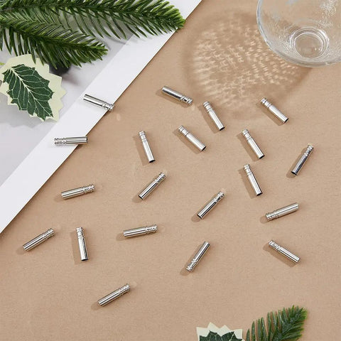 60Pcs Bolo Tie Tips And Cap Buckles Set In Silver Tone, 21.5mm Long With 4mm Inner Diameter, Alloy Bolo Findings For DIY Jewelry Making, Garment Decoration And Craft Projects, Platinum Finish, silver alloy tips on craft surface