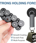 Powerful 40 Lb Neodymium Round Cup Magnets With Countersunk Holes For Wall Mounting Includes Screws Beefy Heavy Duty Industrial Black Magnets 12 Pack Ideal For Tool Organization And Garage Storage, shown held in hand with weight demonstration