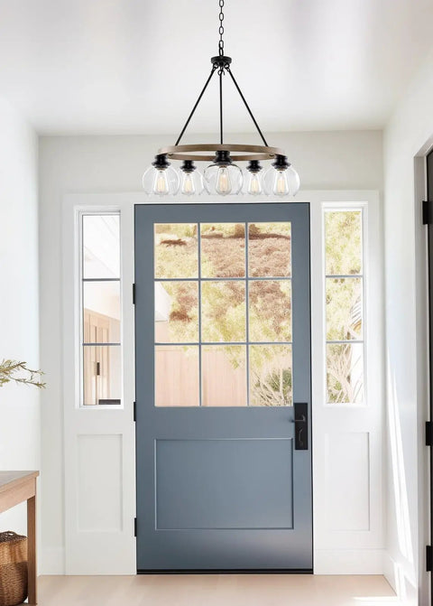 Elwood 25-Inch 5-Light Industrial Rustic Wagon Wheel Chandelier with clear glass globes in bright entryway view