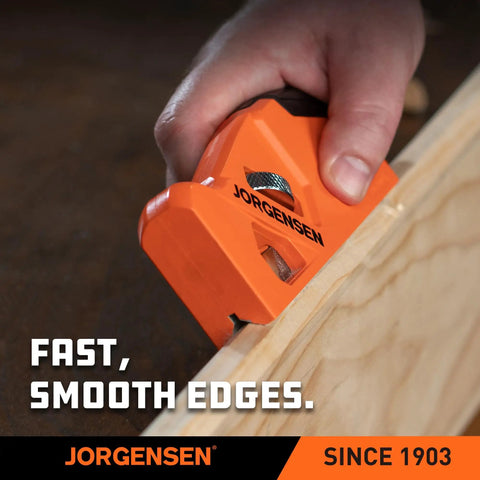 Shop Tough O1 Steel Chamfer Plane With Four Swappable Corner Edging Cutters For Buttery Smooth Wood Trimming And Top Shelf Detail Finishes Plus Dead Easy Built In Storage Keeps Your Garage Gear Tidy And Ready For Any Big Weekend Build. Close-up of an orange chamfer plane used for trimming wood edges.