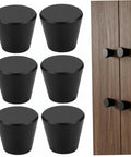 Built Tough Black Round Cabinet Knobs Package Of Six Heavy Duty Aluminum Dresser Handles displayed on furniture with a wood background.
