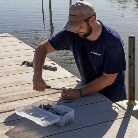 Man using tools next to 12-Inch ProBox Plastic Storage Toolbox For Art Supplies And Crafts, Durable Clear Organizer Case on dock.