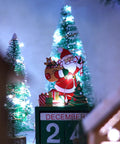 Santa with gifts surrounded by illuminated cool white trees, showcasing the Two Pack 33 Ft 100 LED Battery Operated Fairy String Lights.
