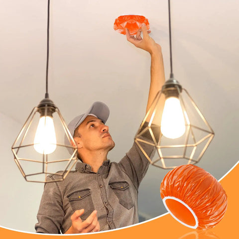 Man placing Orange 24 Piece Elastic Smoke Detector Covers For Cooking Or Baking Thickened Plastic Fire Alarm Shield on ceiling device.
