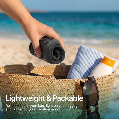Person packing unisex water socks for beach, kayak, pool and travel, quick-dry breathable fabric with cushioned insole, into a bag at the beach.