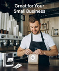 Portable Bluetooth Label Printer With Tape For No Sweat Home Organization Seamless Mobile App Sync Smooth Vanilla Finish Dead Simple Setup Gadget That Always Hits The Spot on a cafe counter with a man packaging a coffee bag.