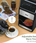 Grind And Brew 10-Cup Coffee Maker With Built-In Burr Grinder, programmable touchscreen, and glass carafe pouring coffee