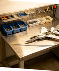 Lightweight Carbon Fiber Rod Set For RC Aircraft And Kite Wings on workbench with model aircraft assembly tools.