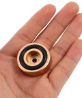 Person holding a golden non slip rubber foot pad with black rim, part of 8 Pcs Non Slip Rubber Feet Pads For Chopping Boards And Electronics.