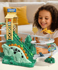 Child playing with Dinosaur Climbing Slide Toy With Racing Track For Toddlers 3 4 5 6 7 8 Light Up Music Themed Car Track Set