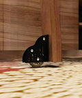 Built Tough Sliding Barn Door Track Kit With Rust Proof Extension Rail And Quiet Floor Roller For Quick Home Or Library Setup Smooth Glide Motion Reliable Structure Handles Three Hundred Thirty Pounds, showing black floor roller under wooden furniture.